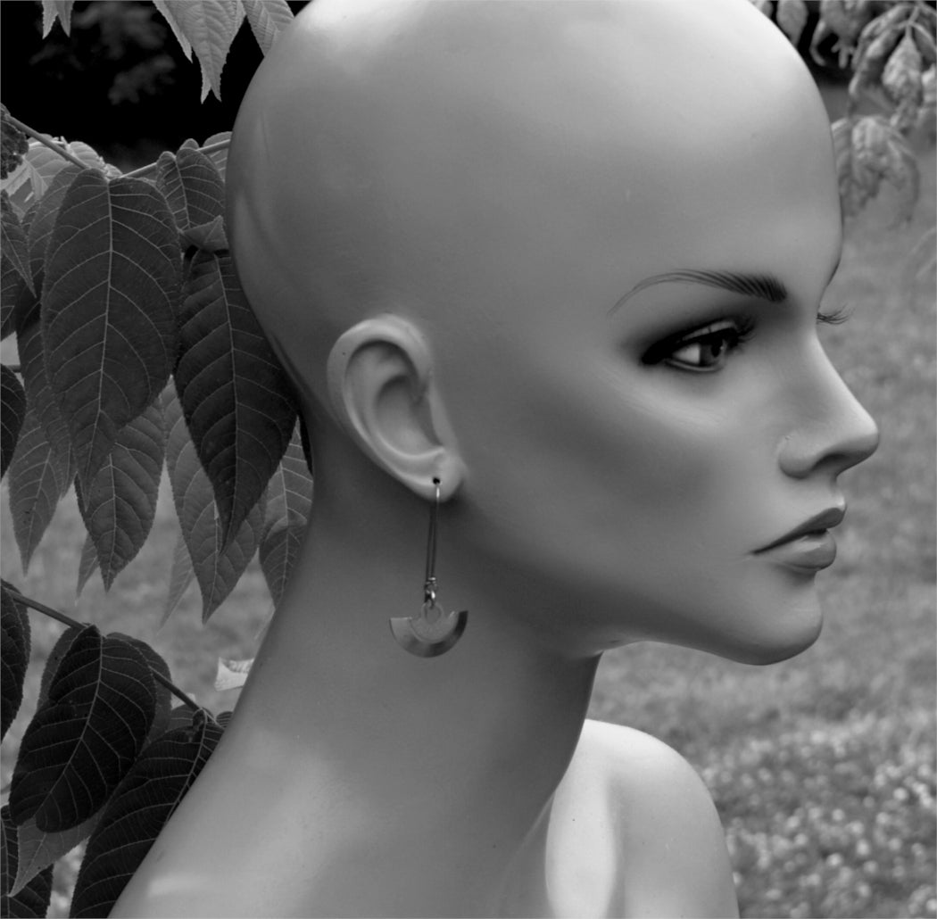 Steampunk earrings in long boho style modeled on a lifesized mannequin.